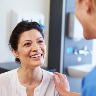 patient happily talking with doctor